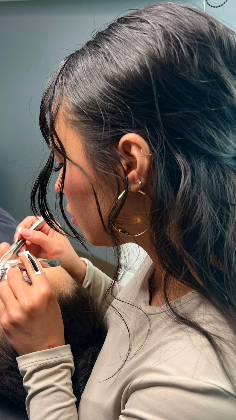 Amber applying lash extensions to a client